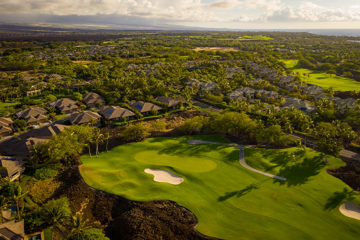 Home situated on Mauna Lani North Course 11th pin, tucked back into private tropical screening while not inhibiting the vista views from the home.