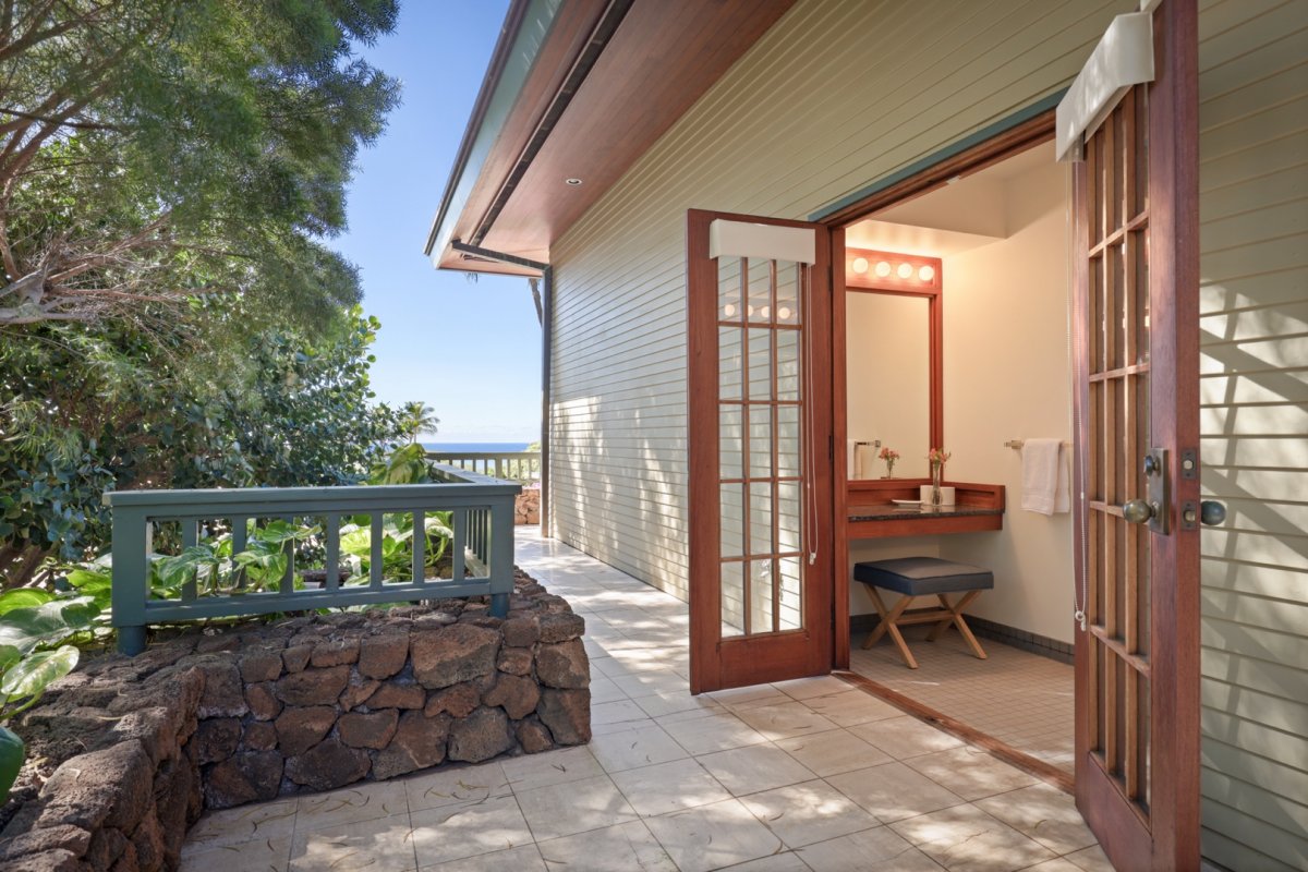 Alternative entry into the en suite bathroom of the primary, which features dual sinks, a walk-in shower and makeup vanity