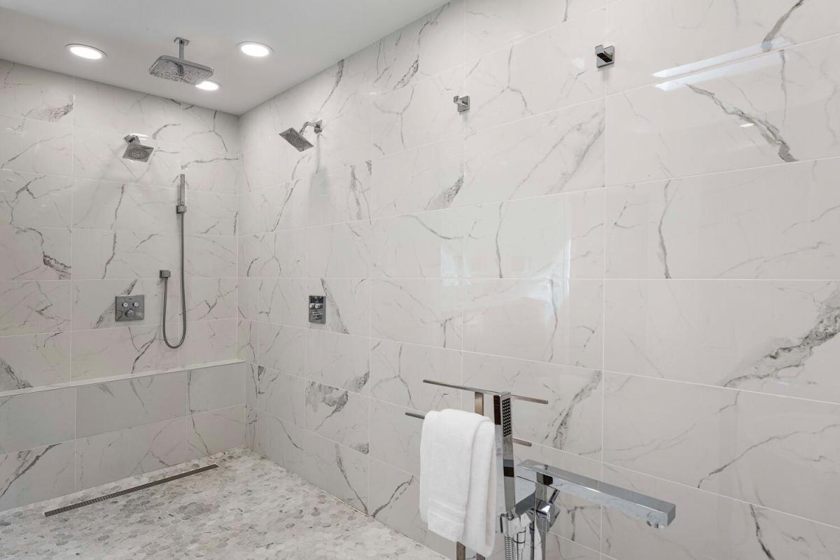 Modern bath with elegant tilework, featuring a walk-in shower and soaking tub combination.