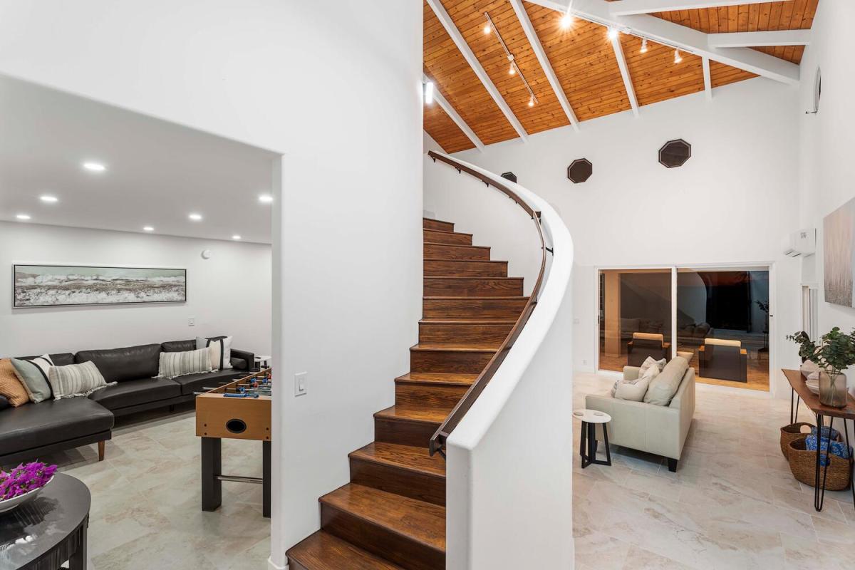 The curvy staircase adds architectural charm while connecting living and sleeping spaces.