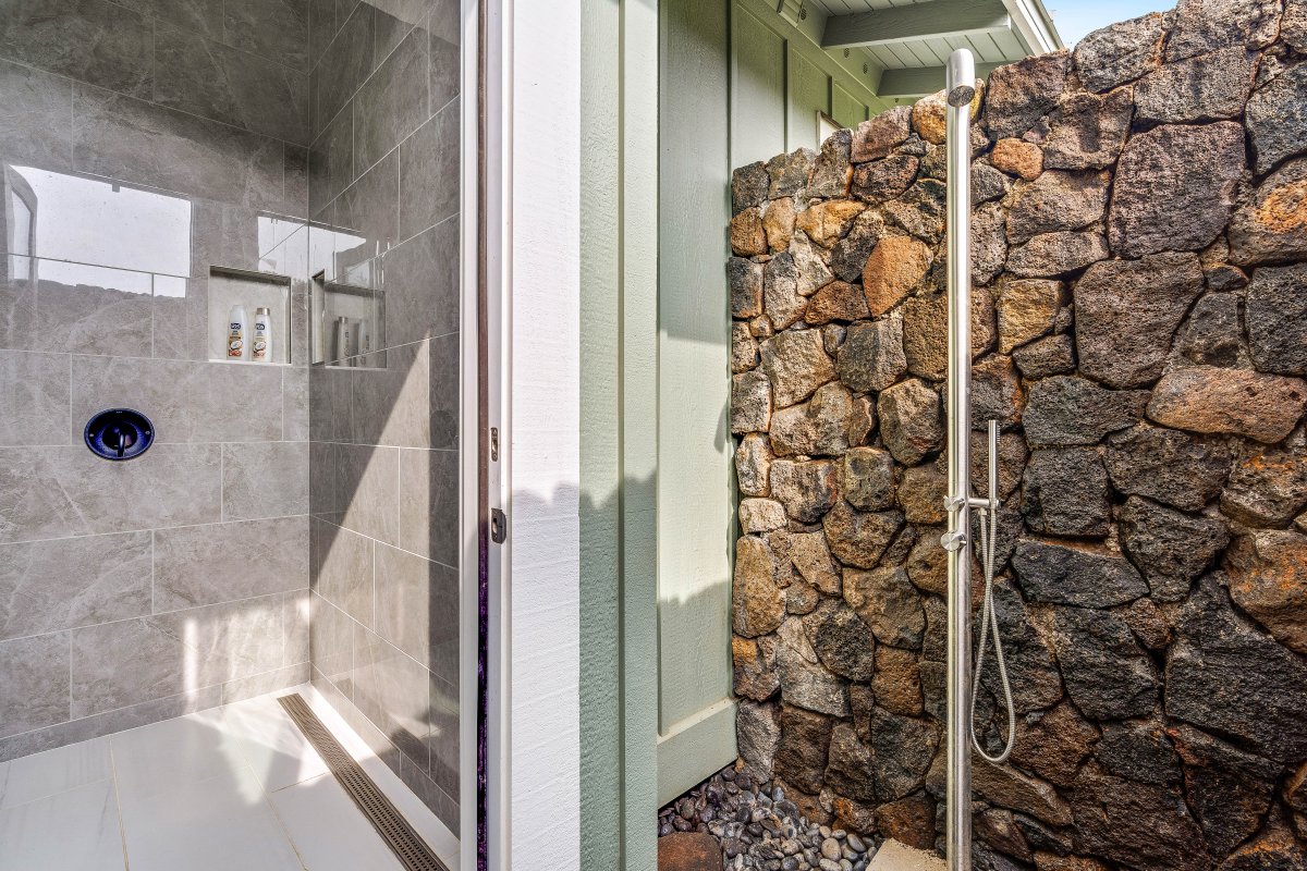 Downstairs bathroom with lava rock outdoor shower