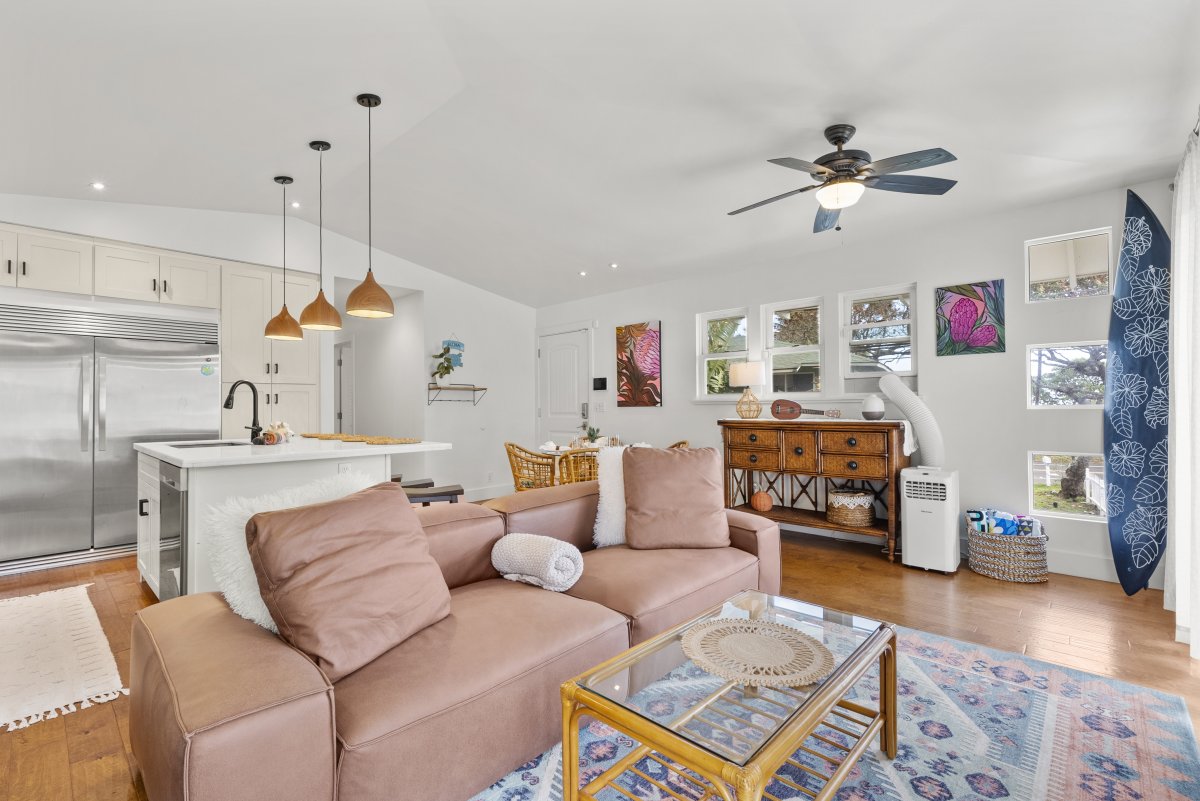 Living area with a cozy couch and a flat-screen TV.