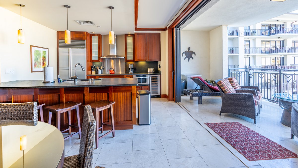 The kitchen is equipped with stainless steel appliances and ocean views.