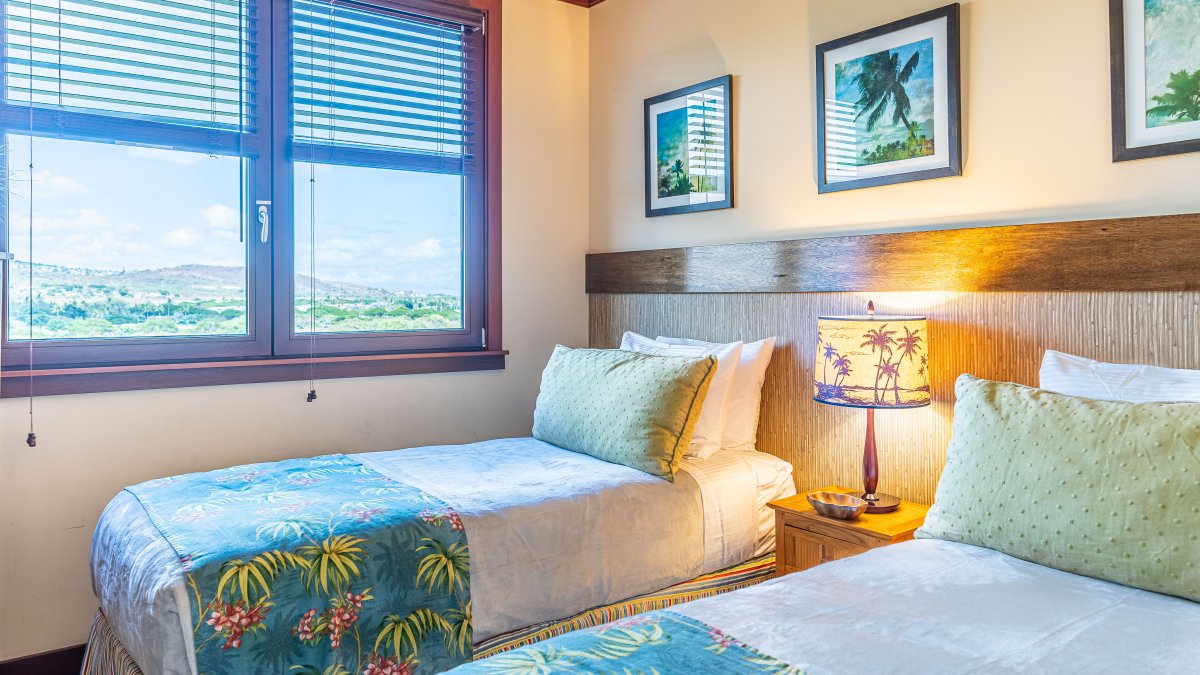 The second guest bedroom with twin beds and bright patterns.