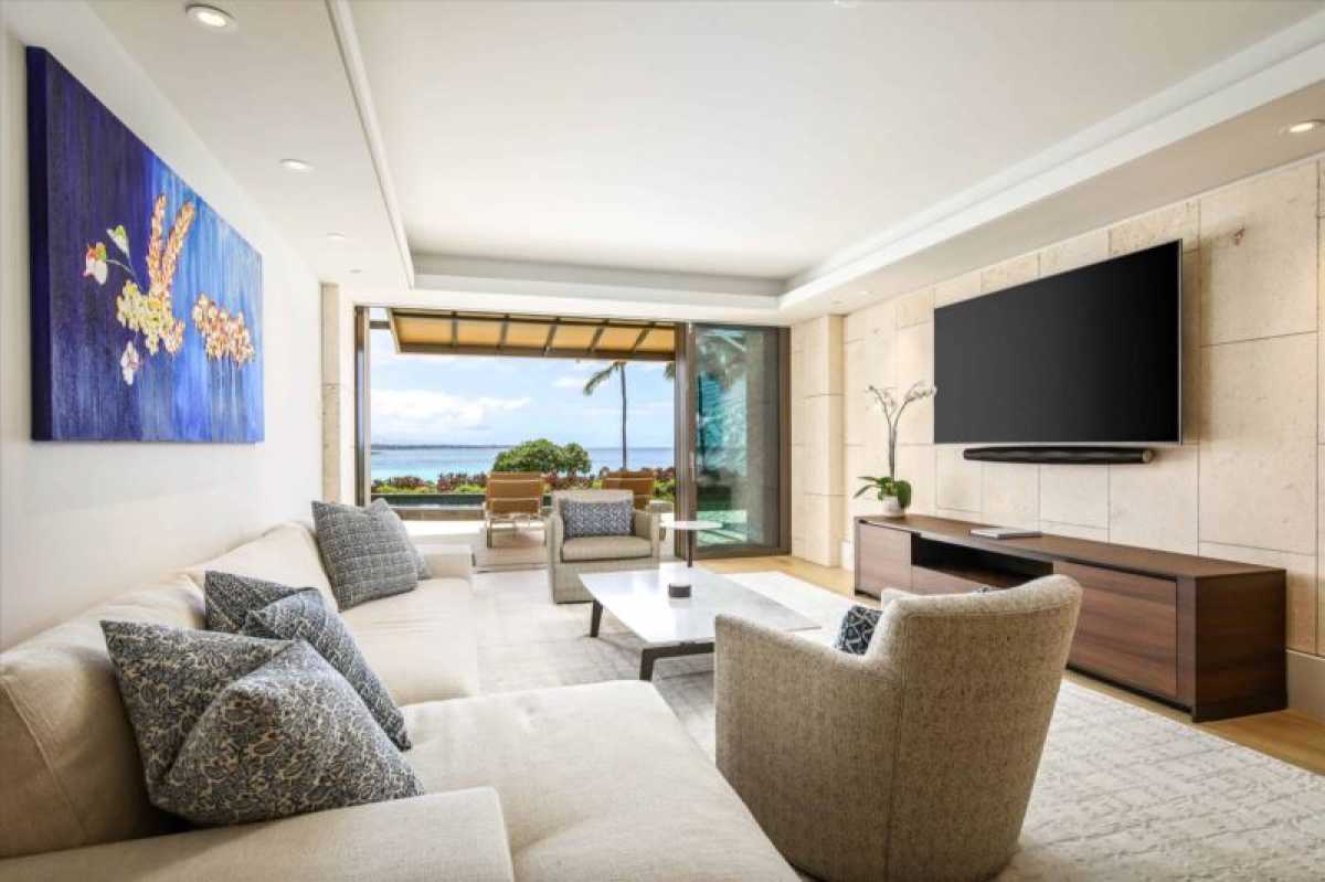 With panoramic ocean views framed by chic modern furnishings, this living room feels like you're living inside a masterpiece