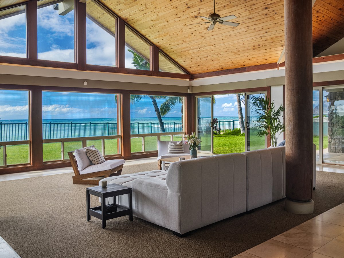 Elegant living room with plush seating, ocean views, and a warm, inviting atmosphere.