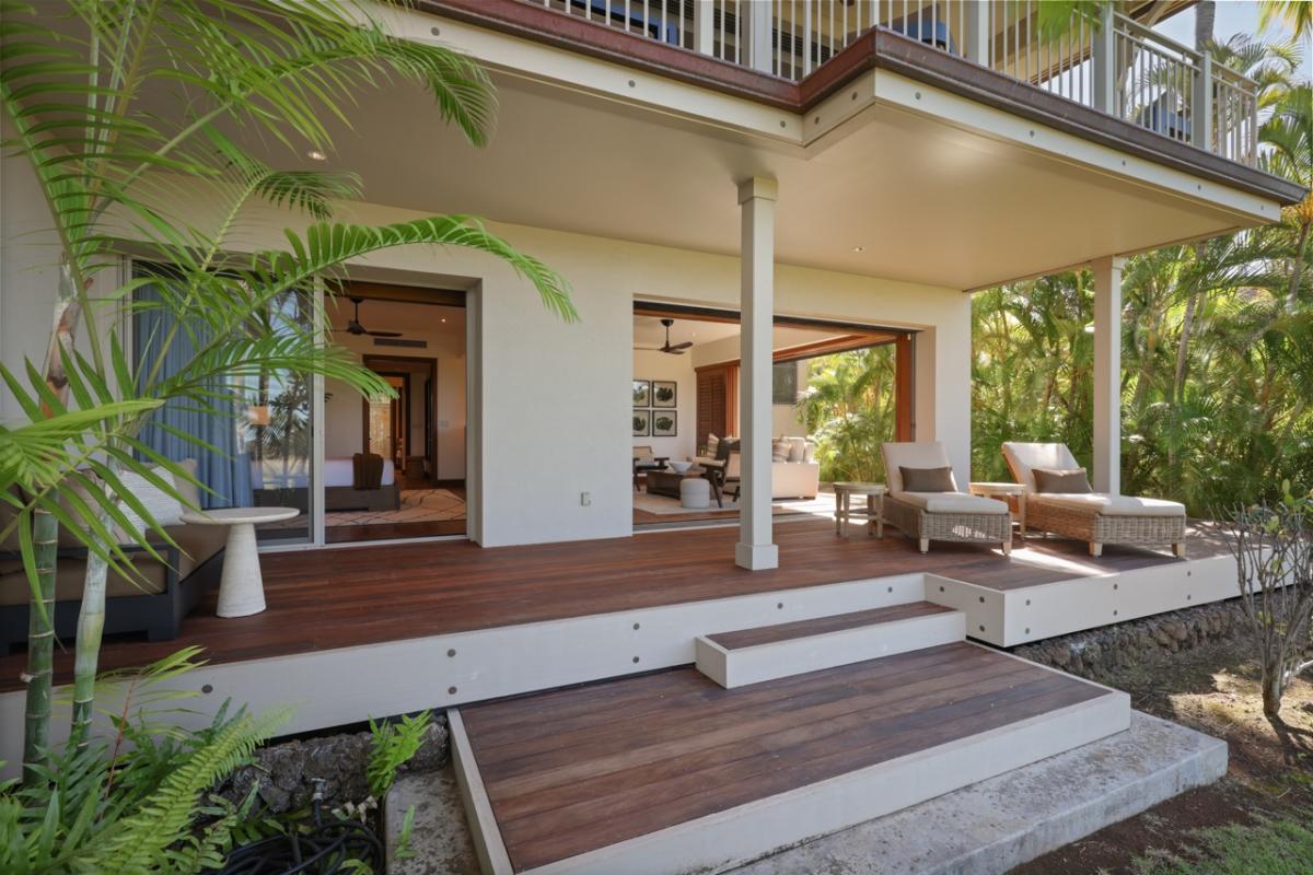 Overall view of the downstairs, back lanai leading into the primary bedroom as well as the media room.