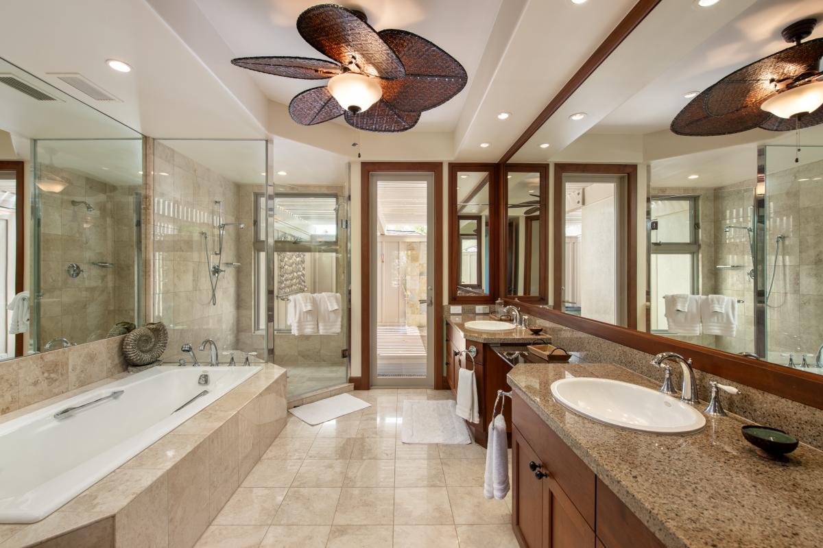 Luxurious primary bath with dual vanities, oversized soaking tub, and walk-in shower.
