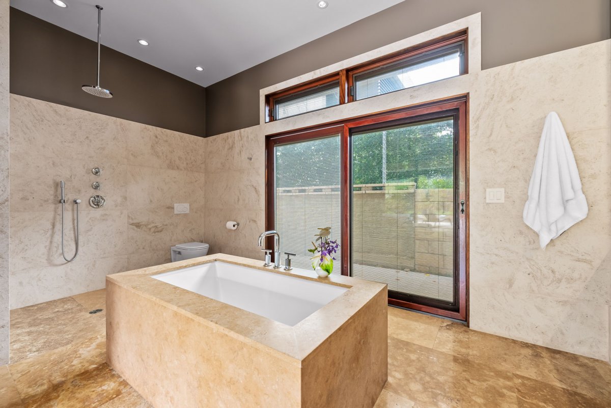 A large soaking tub awaits in the spa-like ensuite bath after a day of exploration.