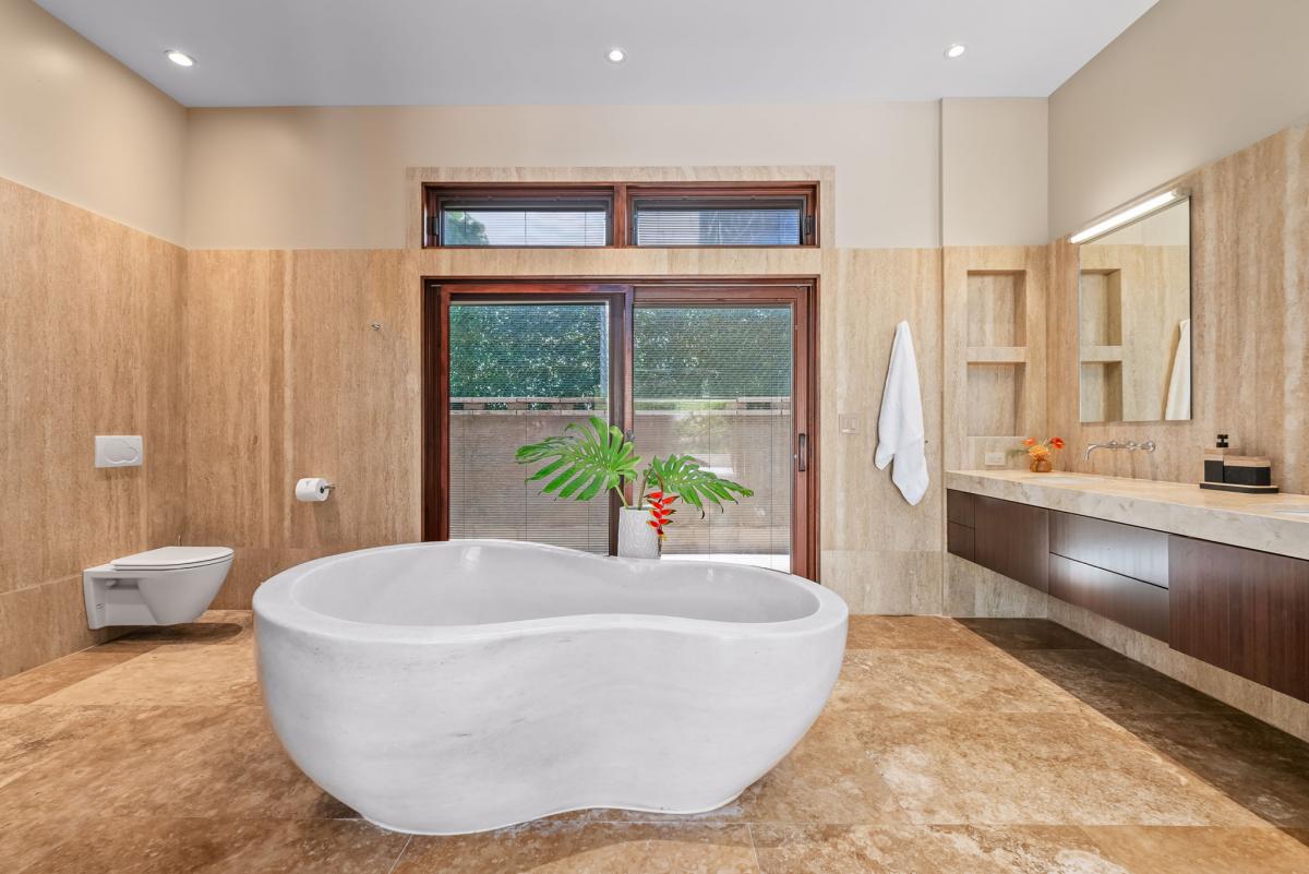 A large soaking tub awaits in the spa-like ensuite bath after a day of exploration.