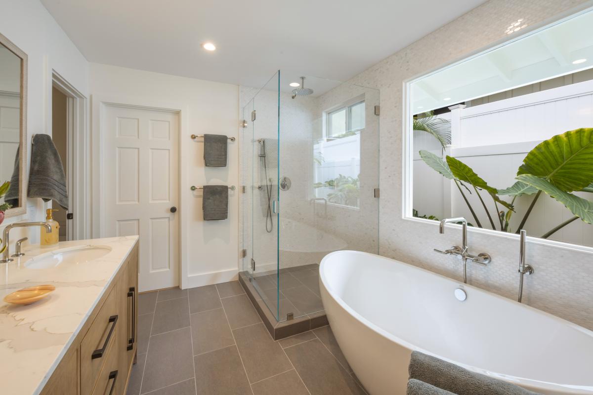 A freestanding soaking tub and glass walk-in shower, bathed in natural light, giving you your own private spa.