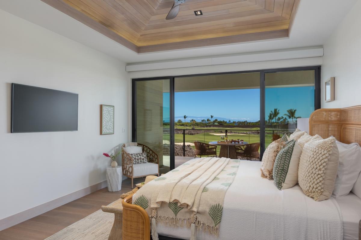 Primary Suite Bedroom 1: This serene bedroom blends comfort with breathtaking views, featuring large sliding doors that open up to the lanai with a lush golf course landscape.