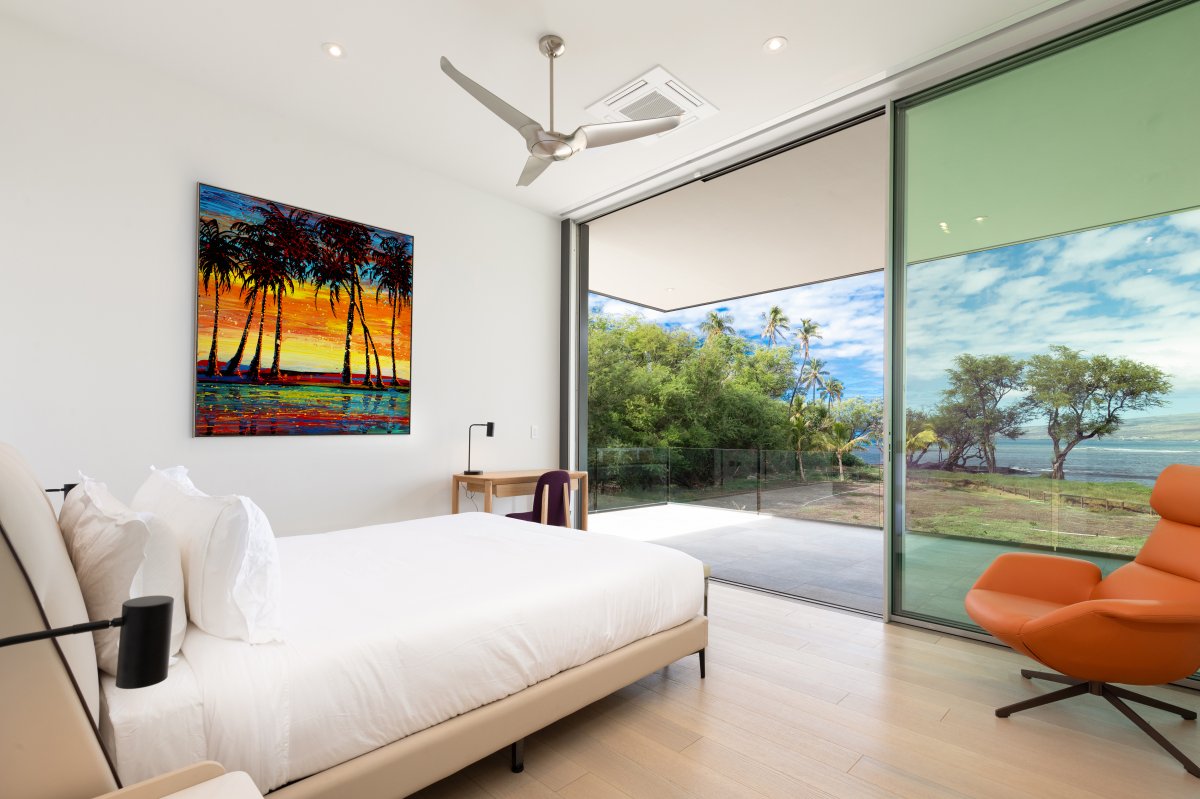 Bedroom 4 features sleek design and expansive sliding doors opening to the serene outdoor view