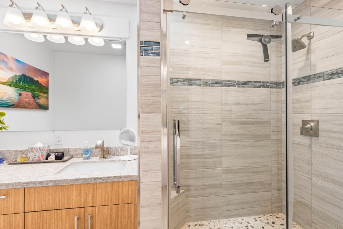 The full bathroom separate walk-in shower in a glass enclosure.