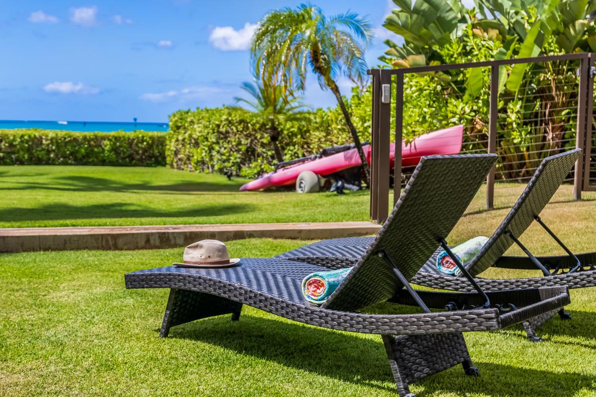 Outdoor chaise loungers on the lawn, perfect for sun bathing.