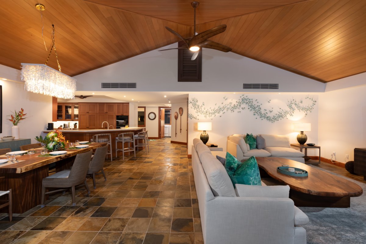 Open-concept living and dining area with vaulted ceilings and stylish decor.