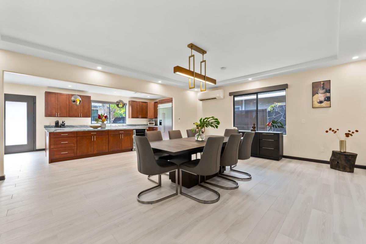 Elegant dining area, good for 8, with modern lighting and open layout