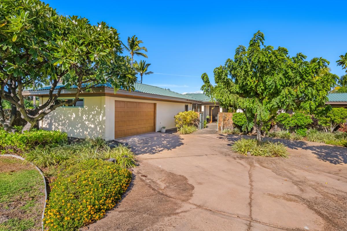 Well-maintained driveway leading to the estate, surrounded by lush landscaping.