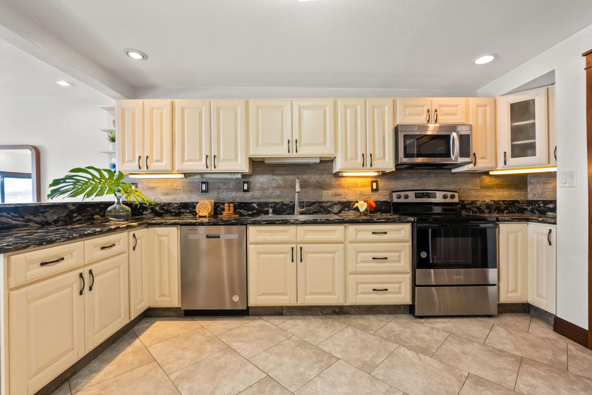 Spacious kitchen with updated cabinets, stainless steel appliances, and natural light.