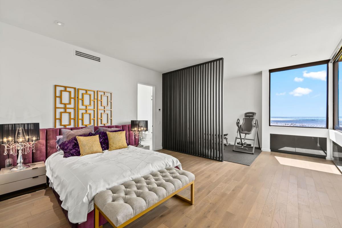 A stylish guest suite with textured wall accents and workspace, ideal for blending work and play during your stay.