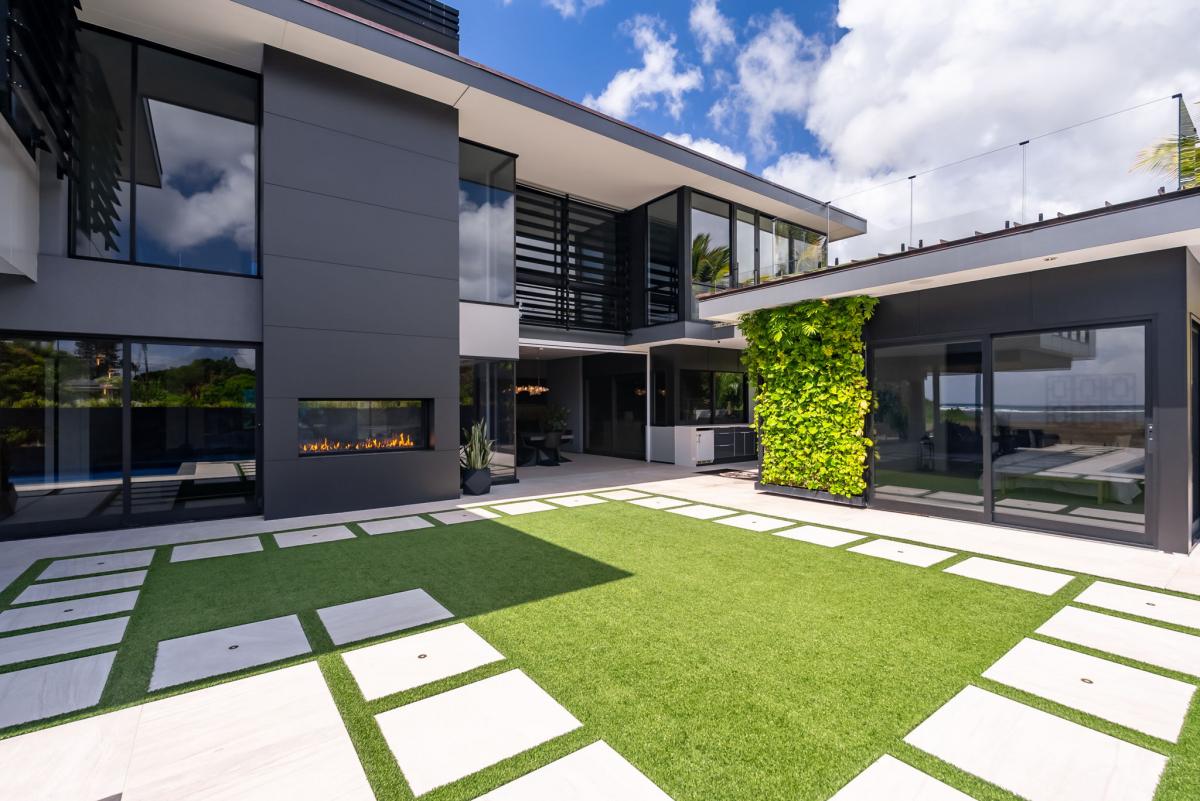 Private central courtyard with lush vertical garden and minimalist stonework—tranquil and refined.