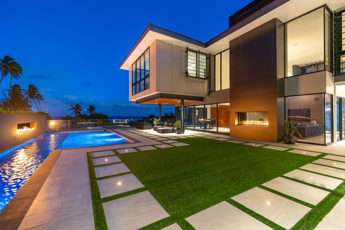 Evenings shimmer across the manicured lawn and pool deck—perfect for entertaining or a romantic sunset swim.