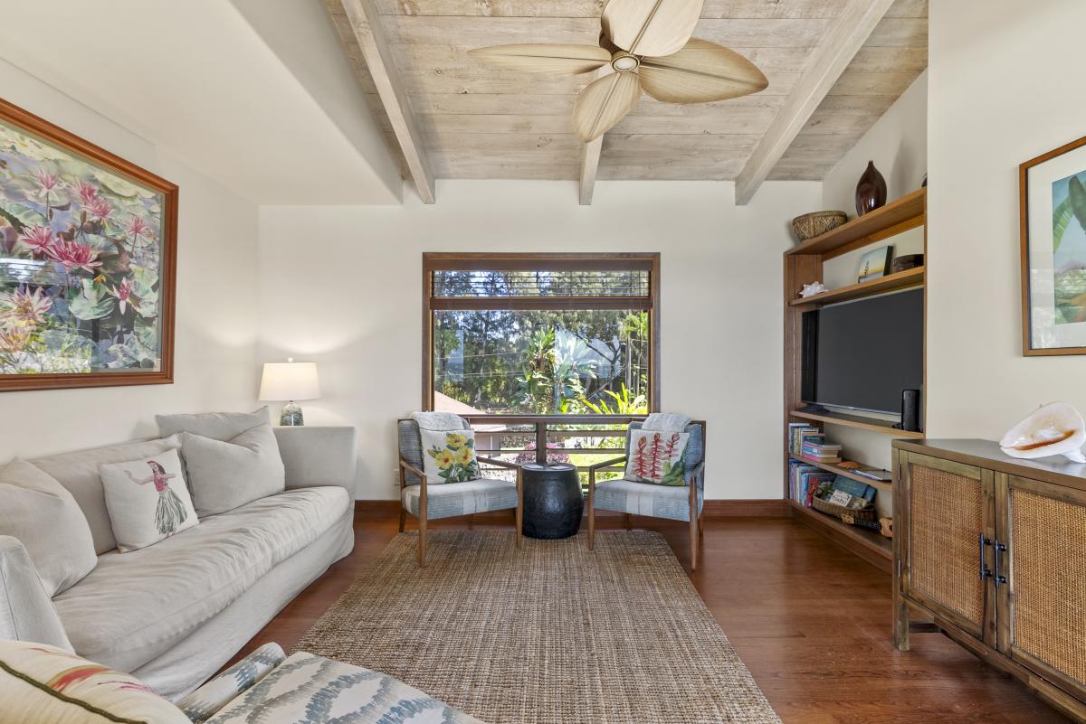 Spacious lounge with plush seating and tropical-inspired décor, ideal for gatherings and relaxation.