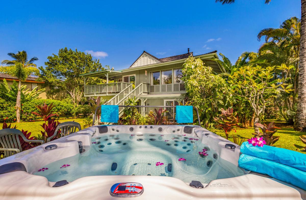 Wake to sweeping views of lush tropical gardens from the upstairs lanai.