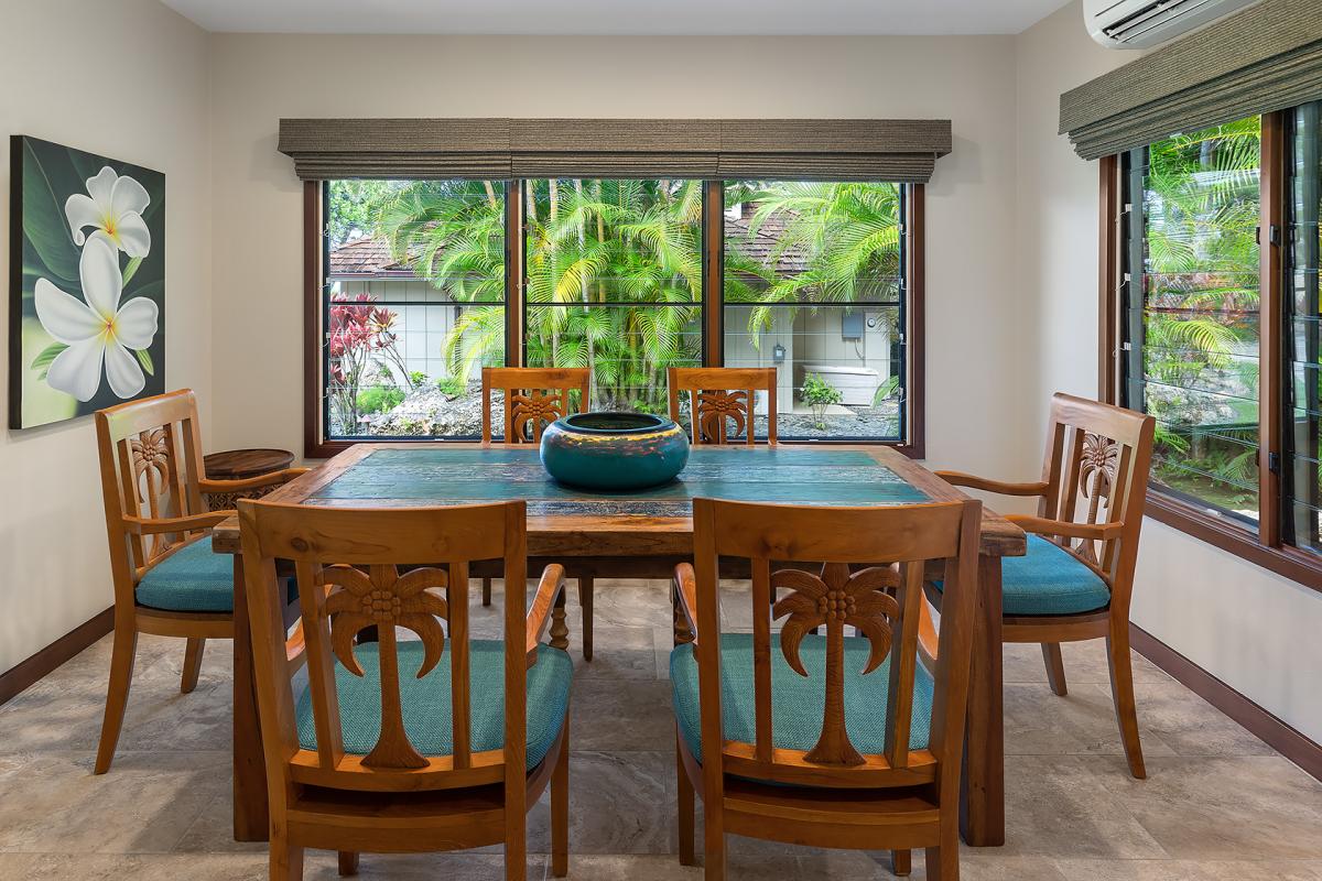 Tennis house dining area with seating for 6, ideal for enjoying meals with garden views.