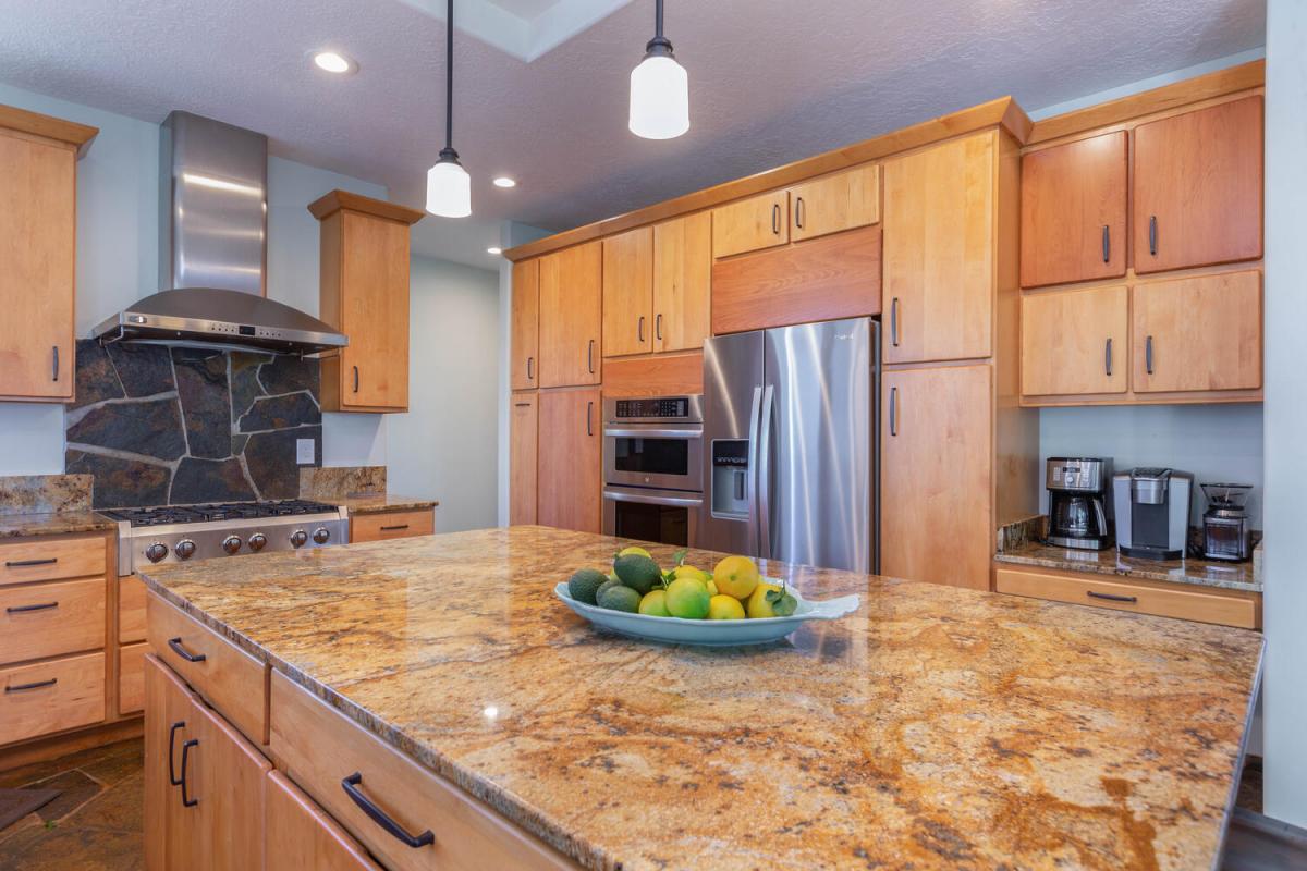 The kitchen features stainless steel appliances and ample cabinetry for storage.