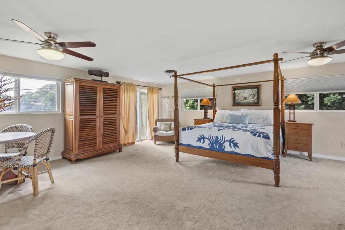 Spacious guest bedroom suite with a king-size bed and outdoor access.