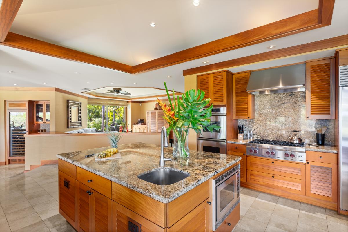 Gourmet kitchen with granite counters, premium appliances, and a generous island—perfect for entertaining or chef-prepared meals.