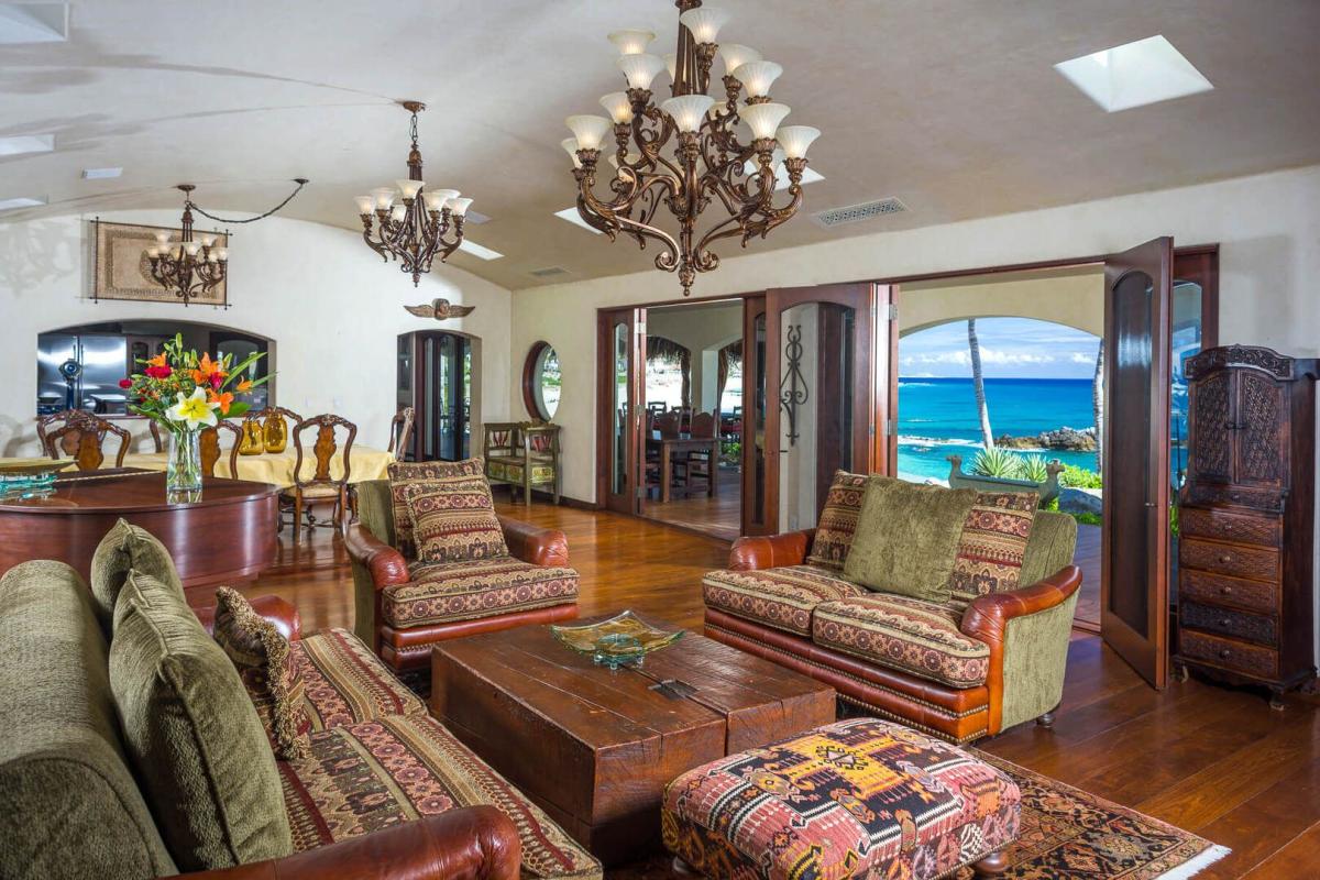 Move from the covered terrace through large open doors into the warm and inviting living area