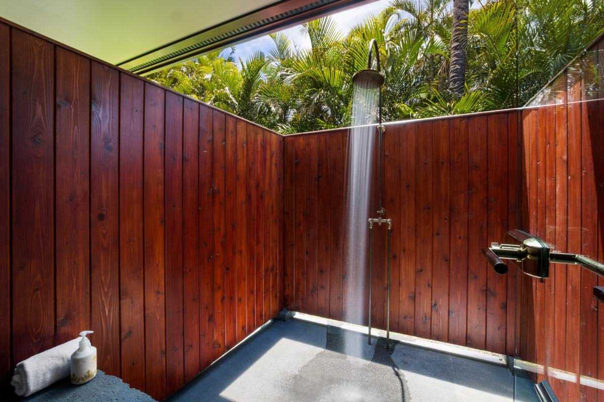 Refresh after the beach in the luxe outdoor shower, tucked behind privacy walls and swaying palms.