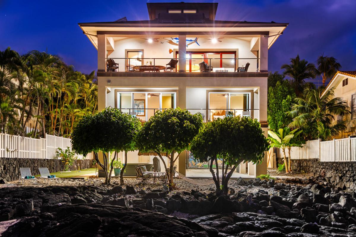 Dramatic uplighting showcases lanais on every level, hinting at the sunset and starlit views that await inside.