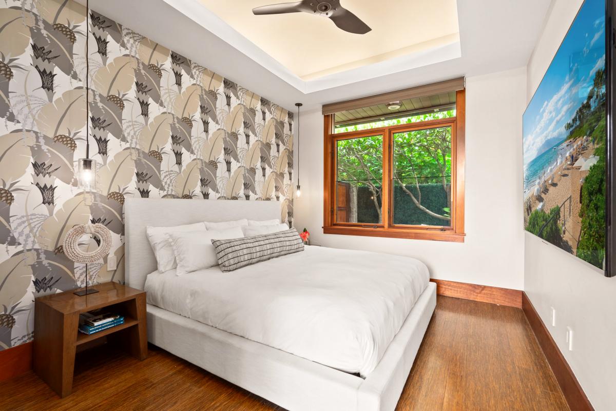 Guest bedroom with king bed and garden view.