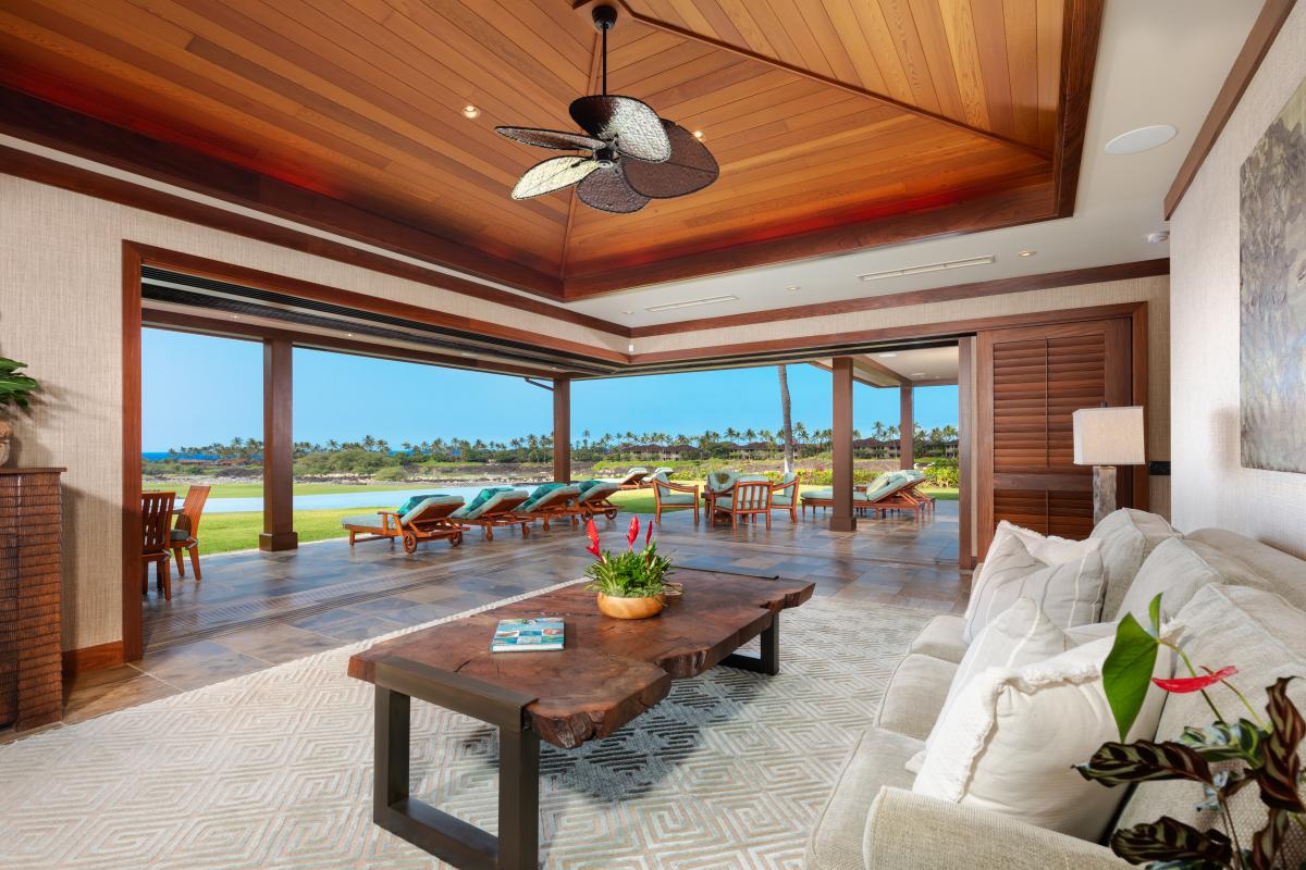 Vaulted wood-inlay ceilings and pocket doors create seamless indoor-outdoor living.
