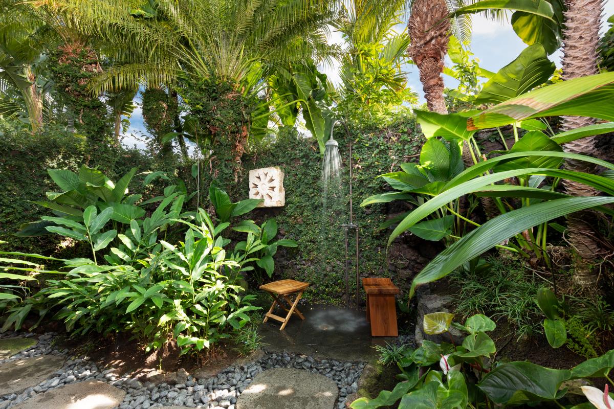 Lush garden outdoor shower for a refreshing rinse surrounded by nature.