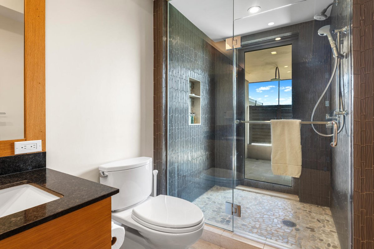 Freshen up in the guest bath featuring a large walk-in shower at Laule'a #14.
