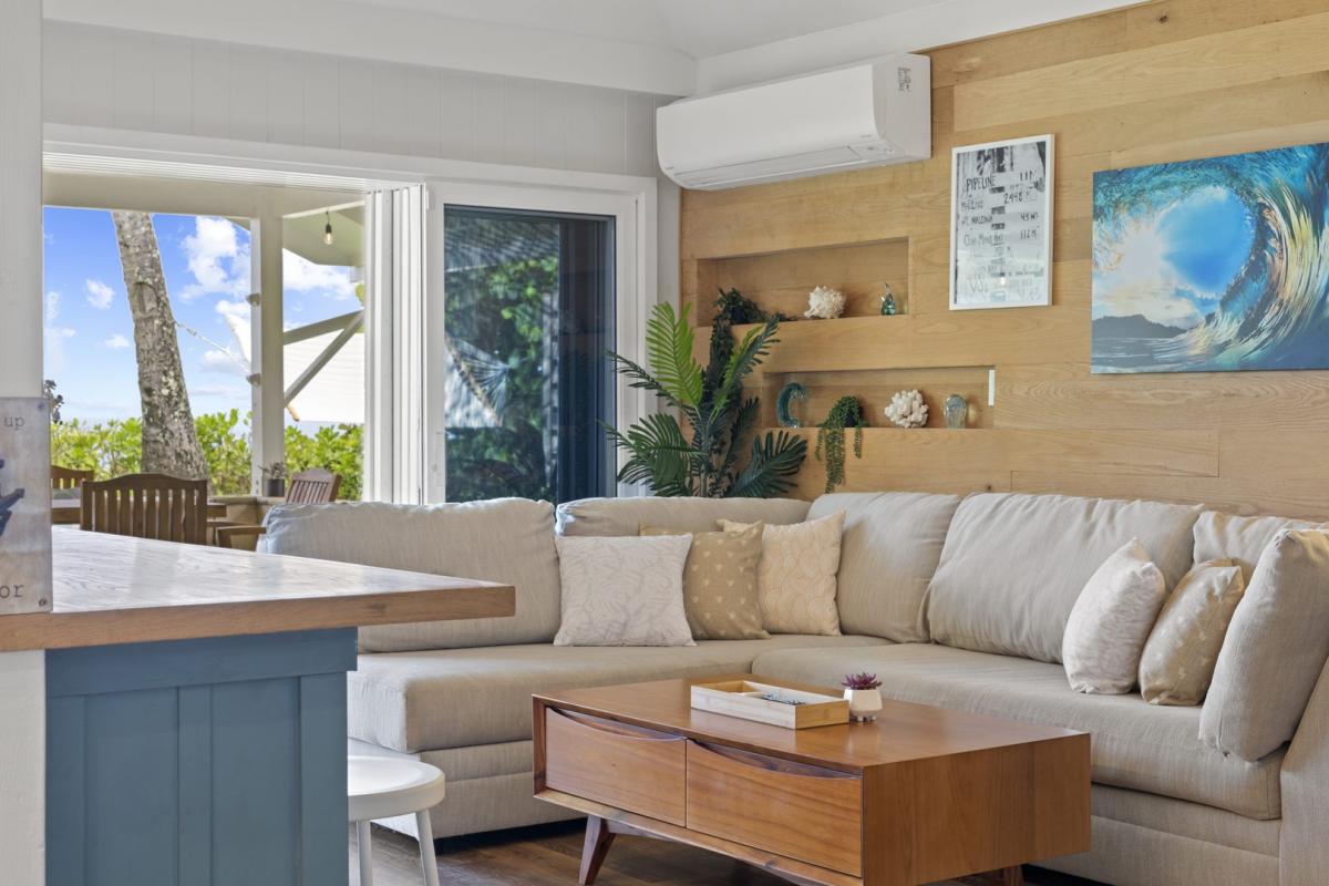 Charming sitting nook with natural light and a plush sectional—perfect for lounging after beach days.