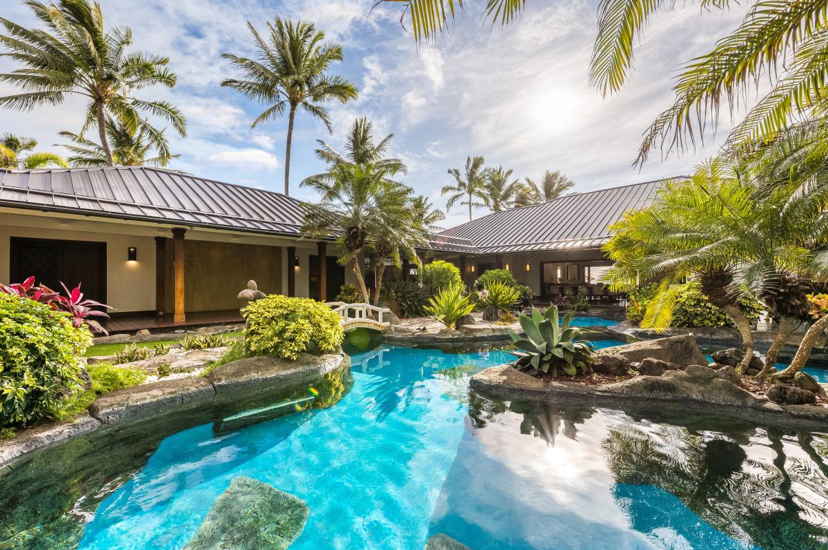 Relax poolside beside a beautiful pool and cascading spa waterfall, framed by panoramic ocean views.