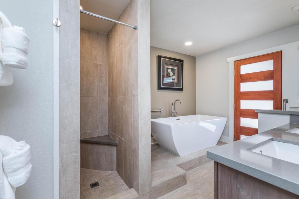 Lani Oasis bath with a modern soaking tub and walk-in shower for spa-like relaxation.