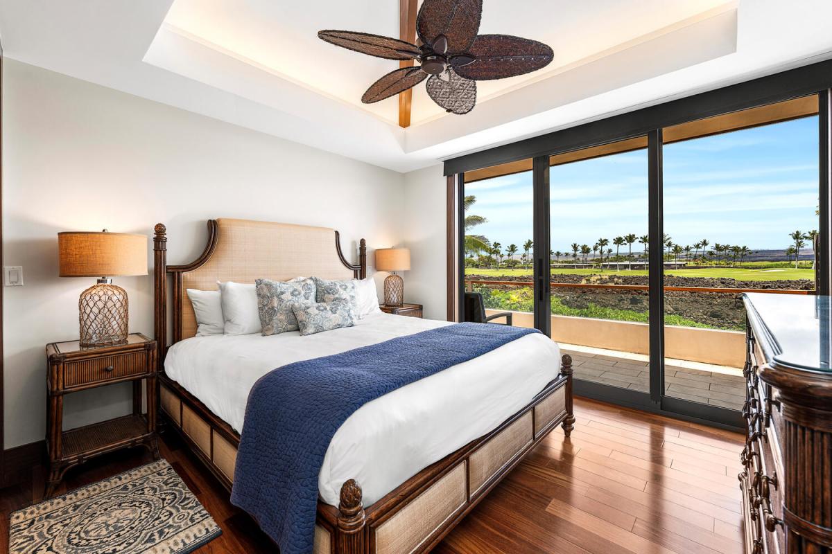 King guest suite with lanai access and rich hardwood floors.