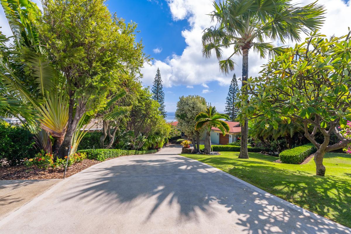 A grand approach lined with palms welcomes you to this exclusive Waialae Iki retreat.
