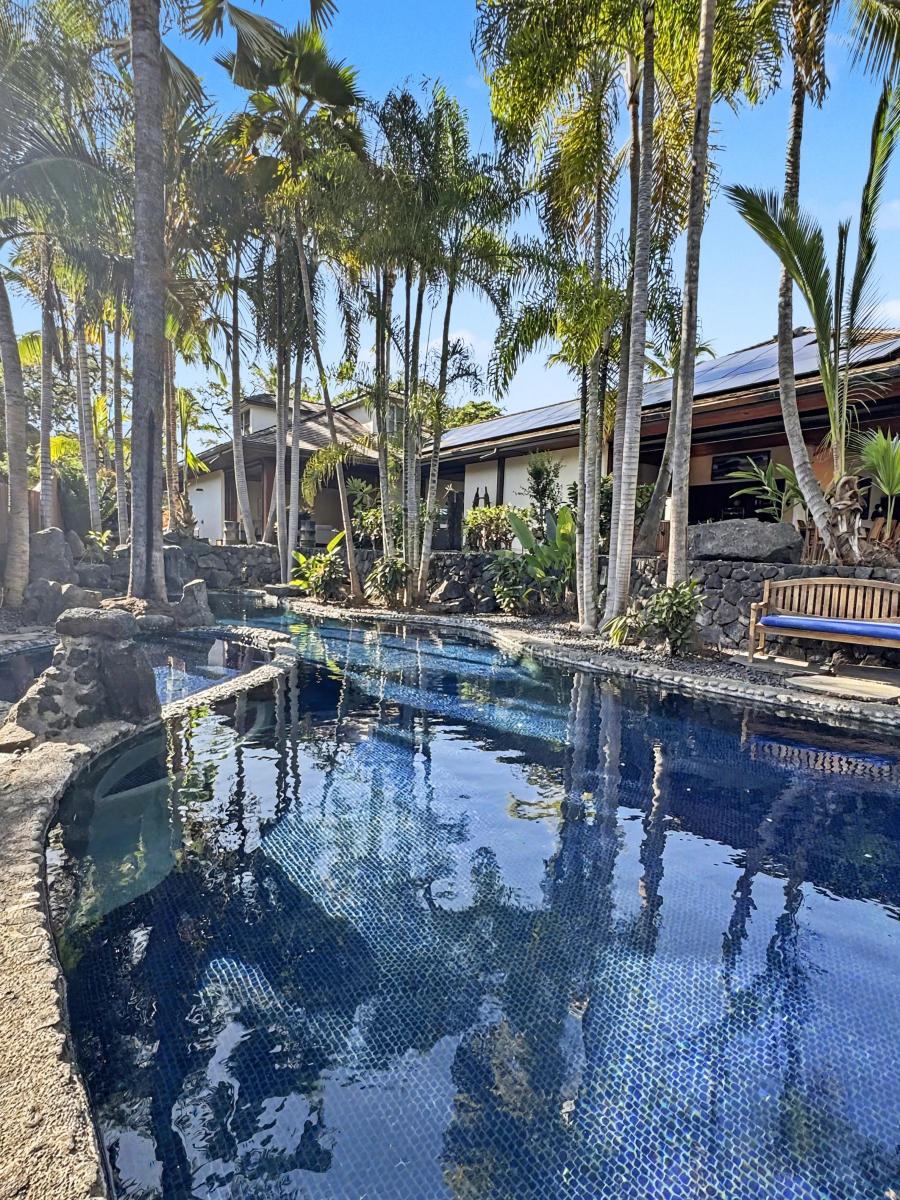 Dive into your private tropical oasis, where crystal-clear waters reflect swaying palms and volcanic stone creates natural beauty around every corner.