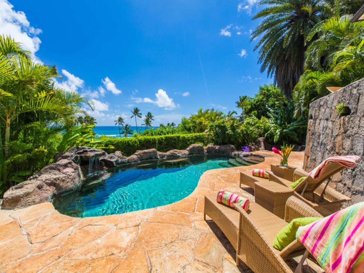 Relax by the private pool with elevated views toward Diamond Head’s famed surf breaks.