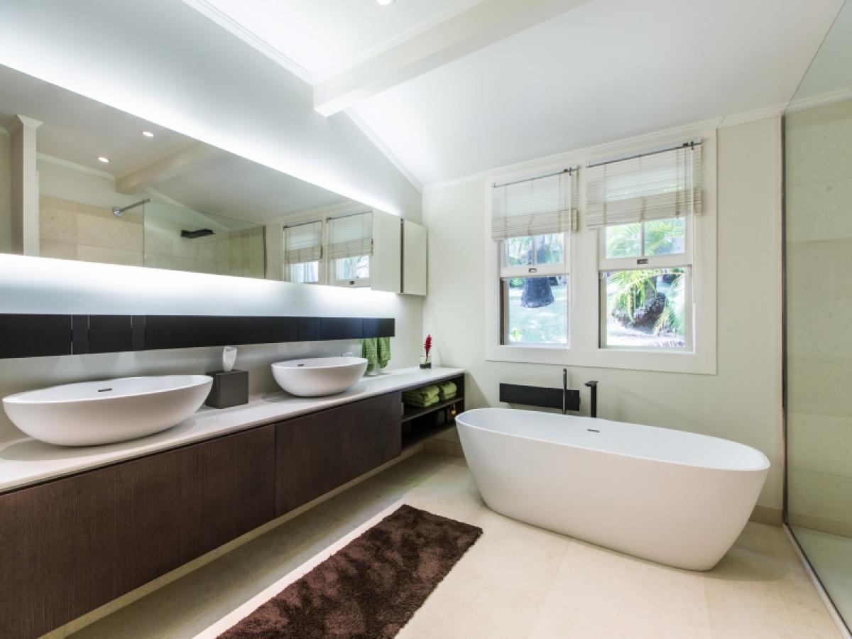 Spa-inspired primary bathroom featuring Agape Italy fixtures and a soaking tub.