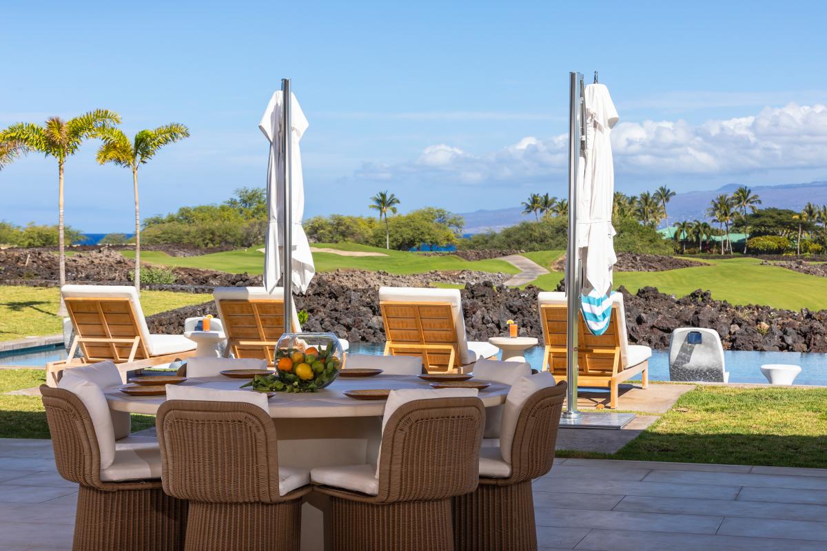 Dine alfresco at your elegant outdoor table overlooking the golf course and ocean, where tropical breezes enhance every meal.