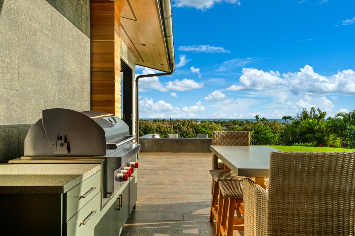 Grill your favorite meals while enjoying tropical views from this stunning outdoor kitchen and dining space.