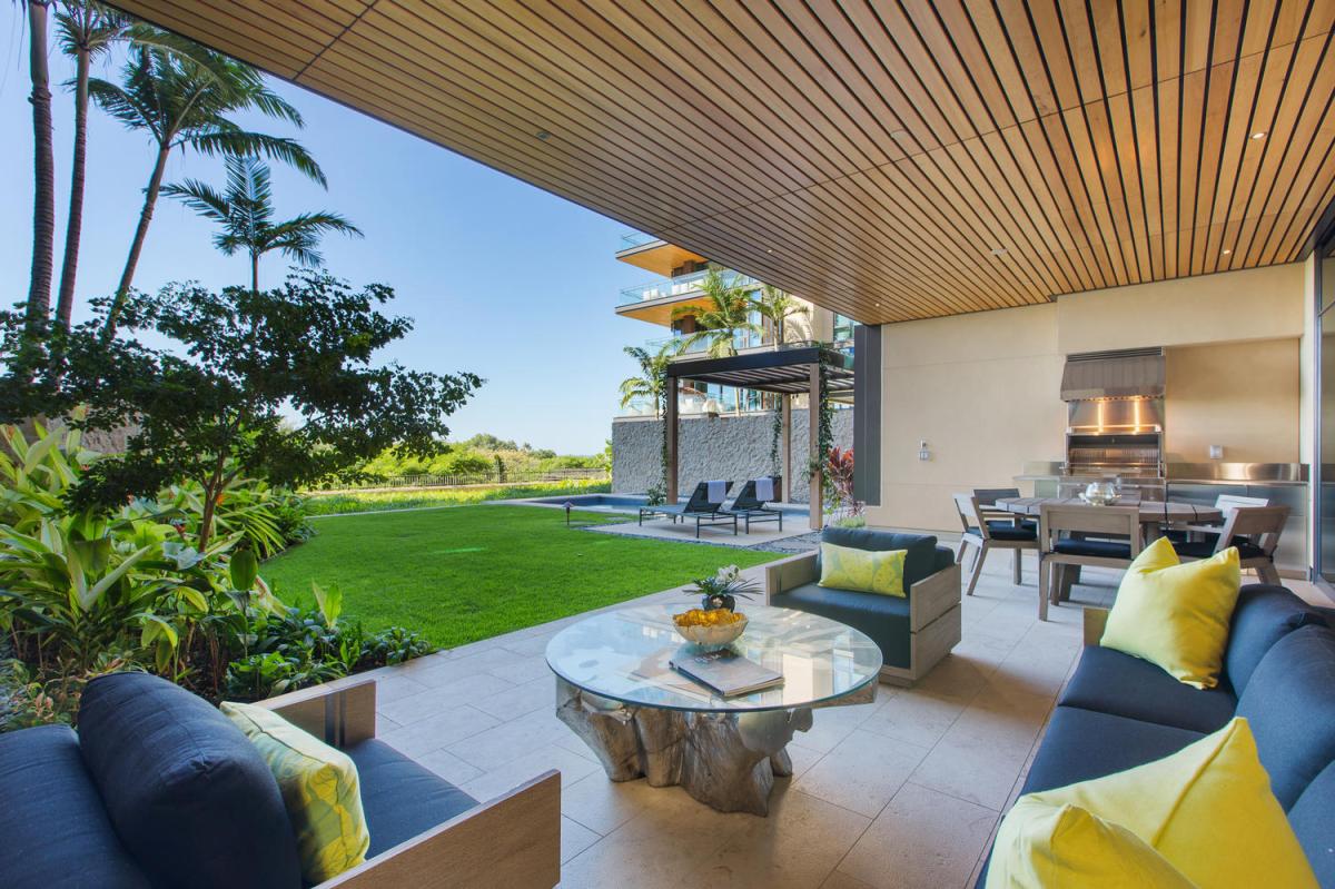 Unwind in your private covered lanai with plush seating overlooking pristine lawns and swaying palms—your perfect tropical retreat awaits.